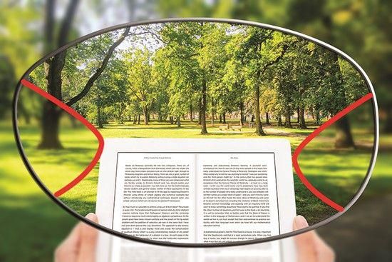 Representação da lente multifocal, cantos embaçados e meio com a imagem de um parque e um livro foco